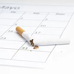 A broken cigarette on a calendar marking quit day